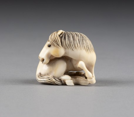 Auktion <br>EIN GESCHNITZTES NETSUKE EINES PFERDES AUS ELFENBEIN