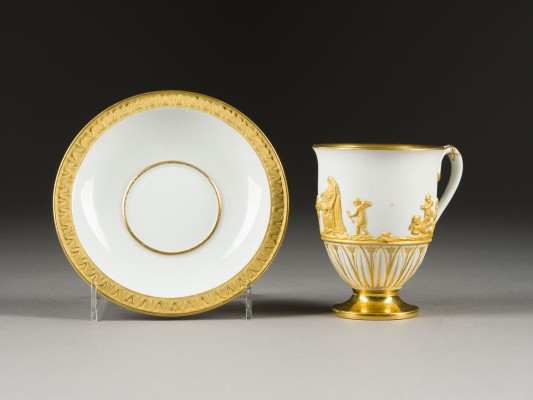Auction 141<br>TASSE MIT UNTERTASSE MIT ANTIKISIERENDEM RELIEFFRIES