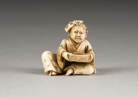 Auktion 148<br>EIN GESCHNITZTES NETSUKE MIT EINEM RUHENDEN SCHAUSPIELER AUS ELFENBEIN