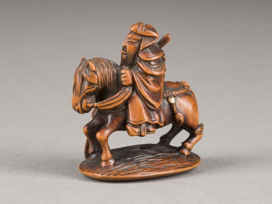 Picture EIN NETSUKE VON KAN'U AUS HOLZ