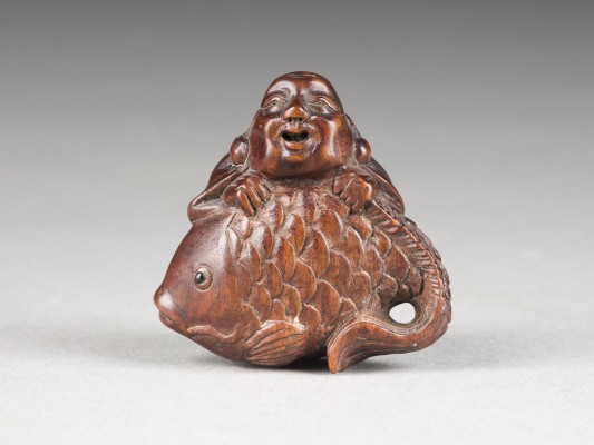 Auction 148<br>EIN FEINES NETSUKE VON HOTEI UND KARPFEN AUS HOLZ